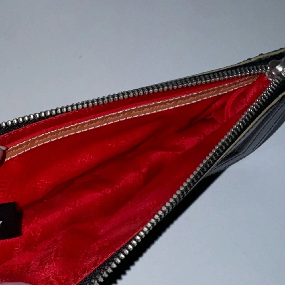 Ellen Tracy Black Leather Clutch with red logo interior.